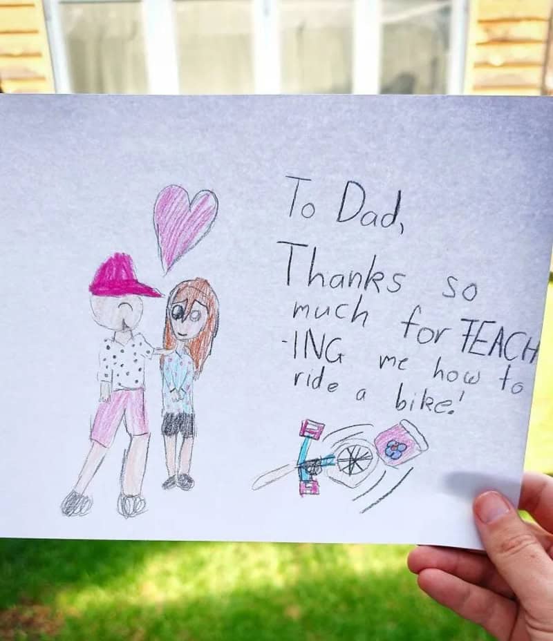 Child's thank you note with drawing of dad and daughter, bike, and heart.
