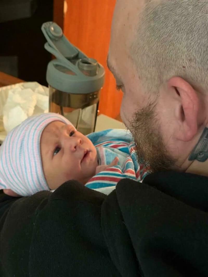 Father and baby sharing a close moment, baby looking up at dad.