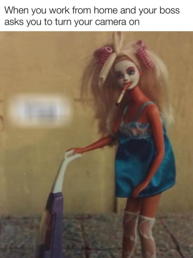 Doll with blonde hair, pink curlers, blue dress, holding a vacuum, cigarette in mouth.