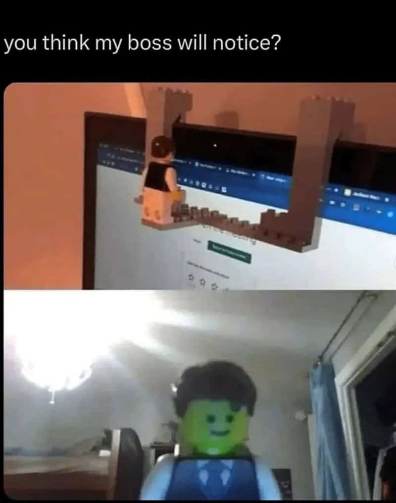 Person with a LEGO head looking at a computer screen with a LEGO figure on top.