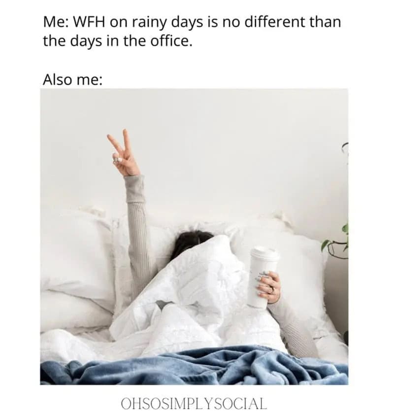 Person in bed with coffee, making peace sign, in a cozy home setting.