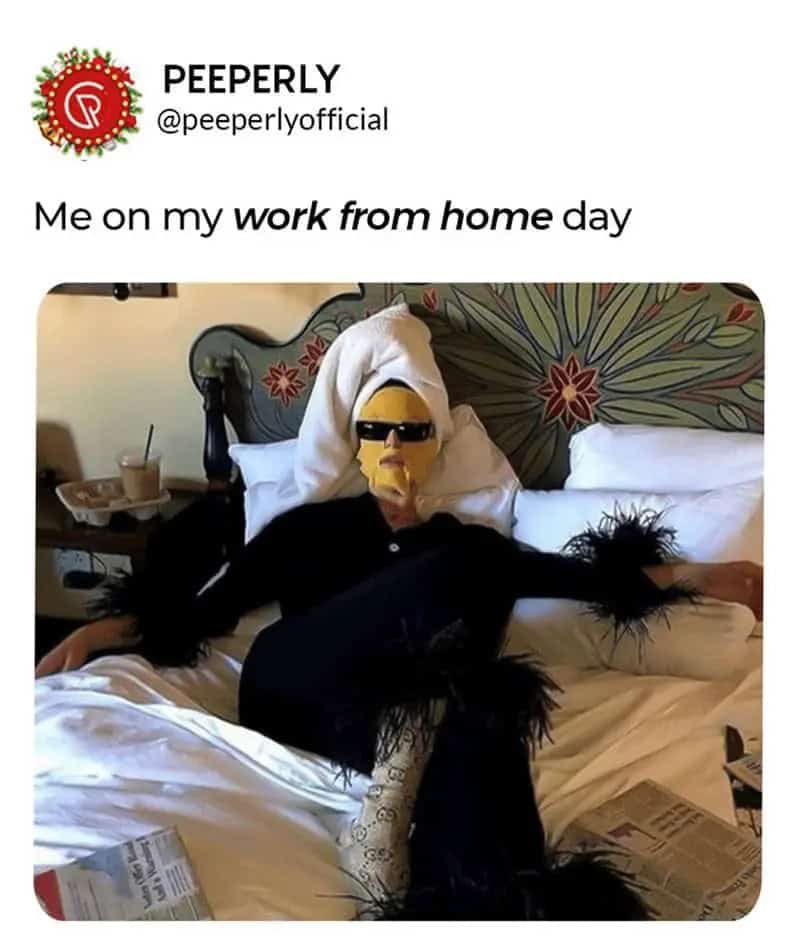 Person in a black outfit with sunglasses lying on bed with a towel on head.
