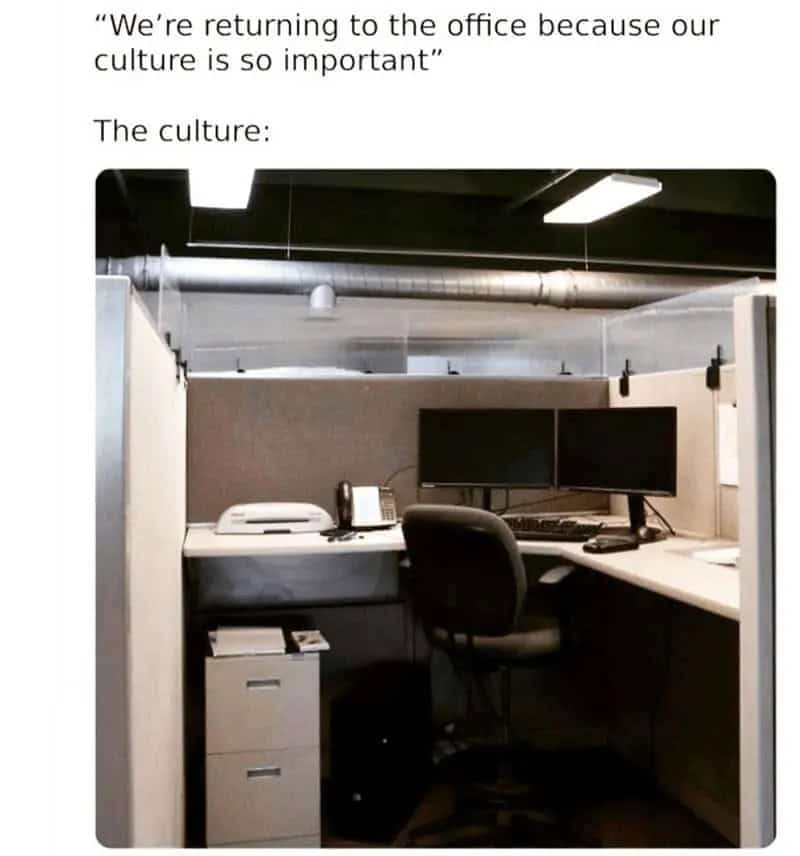 Office cubicle with dual monitors, a phone, and a chair, under a quote about returning to the office.