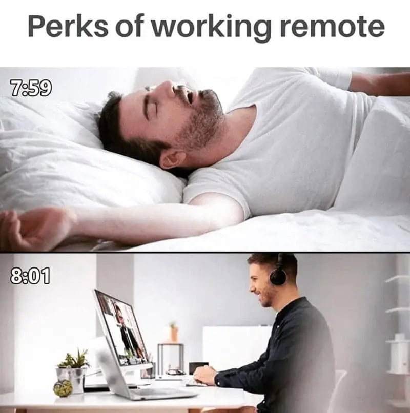 Perks of working remote: sleeping in and working at a desk with a computer.