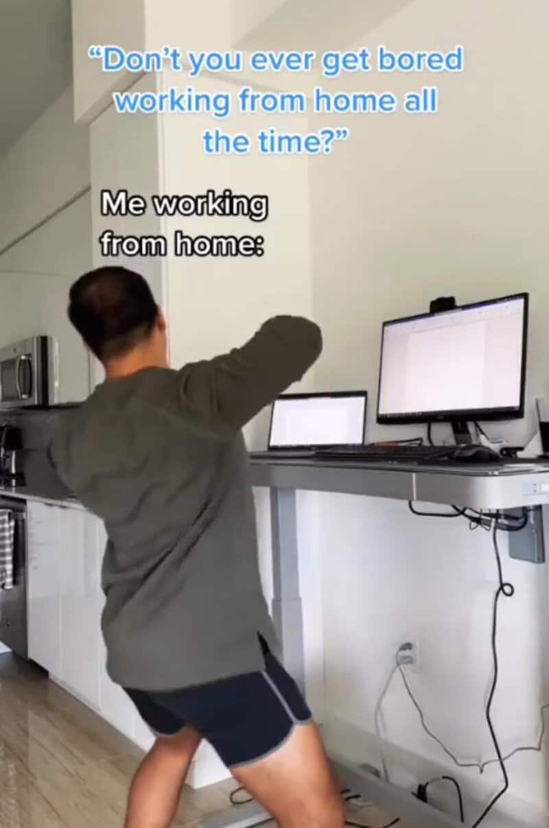 Person working from home with two monitors, text overlay about boredom and working from home.