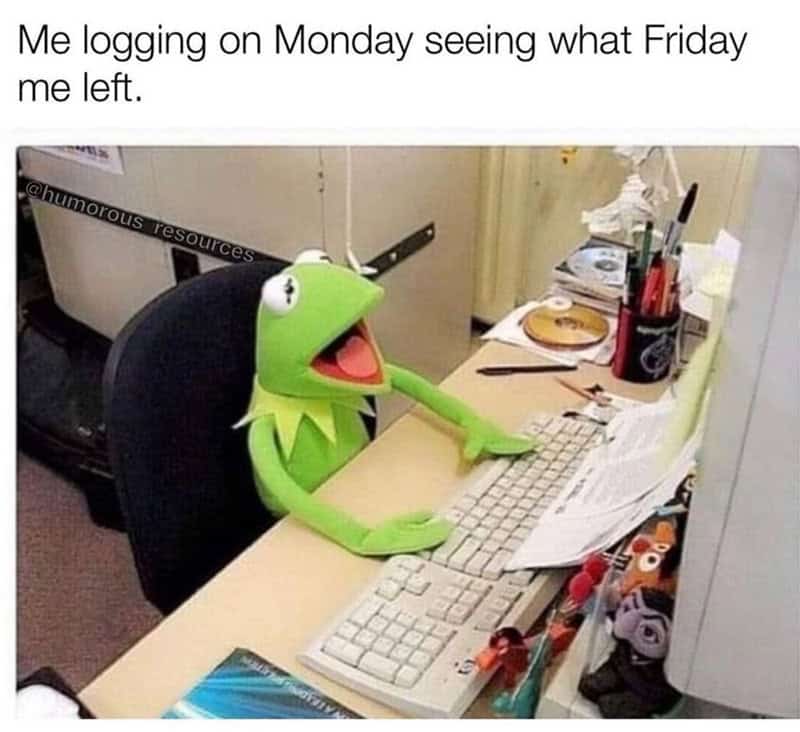 Kermit the Frog puppet at a desk with a keyboard and papers, looking surprised.