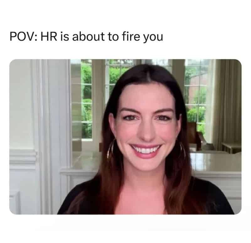 Woman smiling with text: POV: HR is about to fire you.