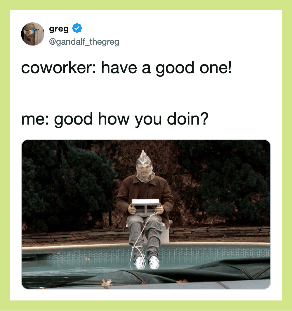 Person with a paper bag over their head sitting by a pool with a laptop.