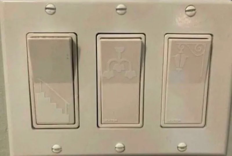 Switches with stairs, faucet, and light icons, all in one panel.