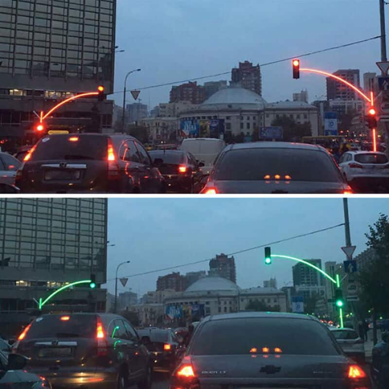 Traffic lights with red and green signals in an urban setting during dusk.