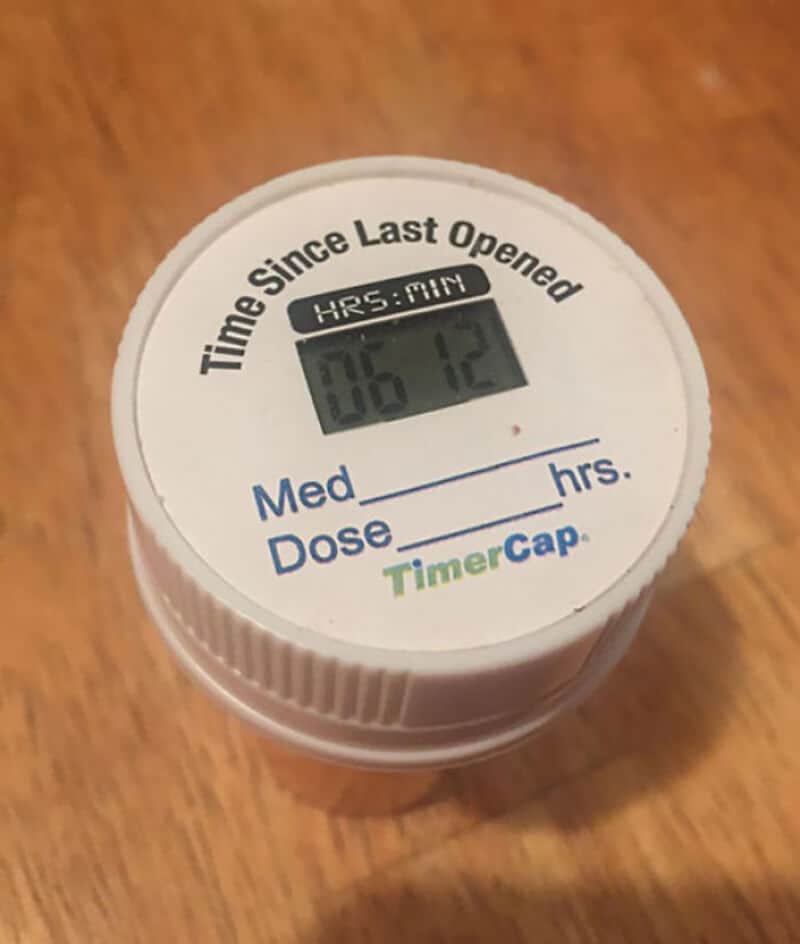 TimerCap medication bottle with digital display showing 06:12, labeled 'Time Since Last Opened' and.