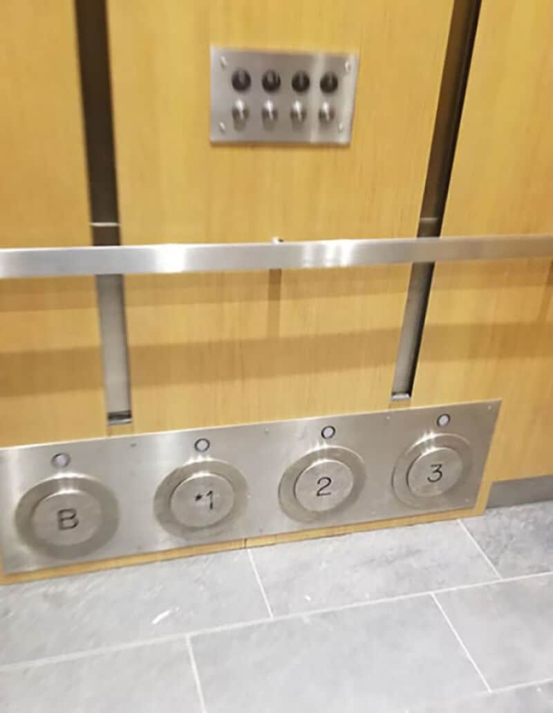 Elevator control panel with buttons labeled B, -1, 2, 3 and a separate panel with black dots.