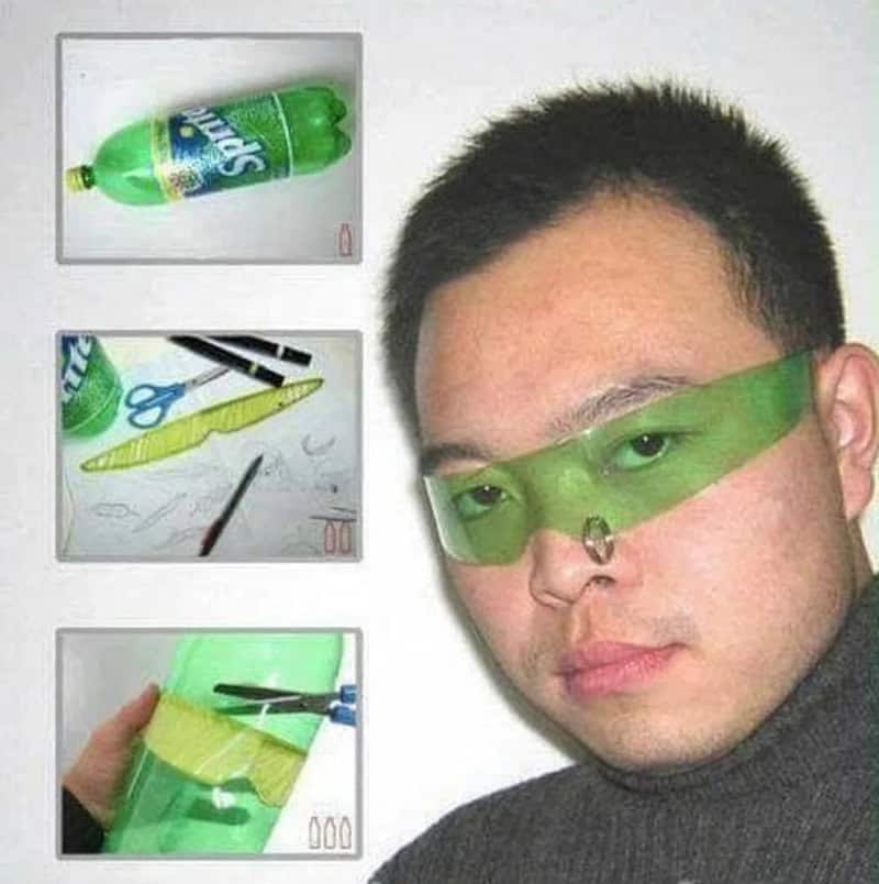 Person wearing green plastic glasses with a nose clip, with craft supplies shown.