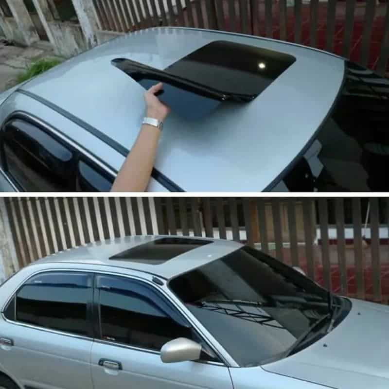 Person attempting to open sunroof on silver car with a hand on the roof.