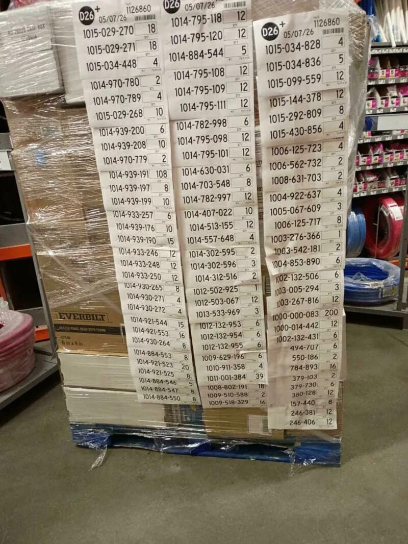 Pallet with barcode labels at Home Depot, showing product codes and prices.