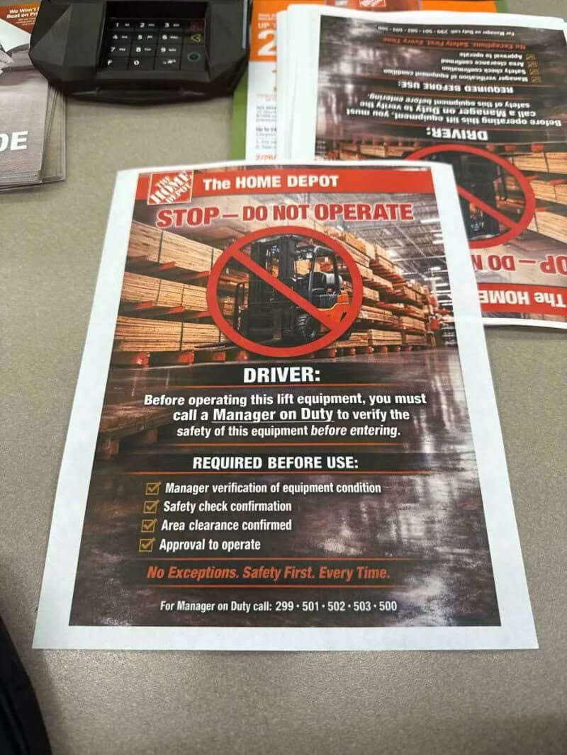 Warning sign at Home Depot about lift equipment safety and verification.