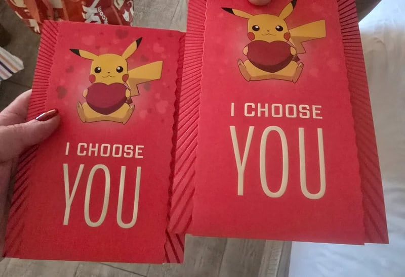 Pikachu holding a heart with the text "I CHOOSE YOU" on red paper.
