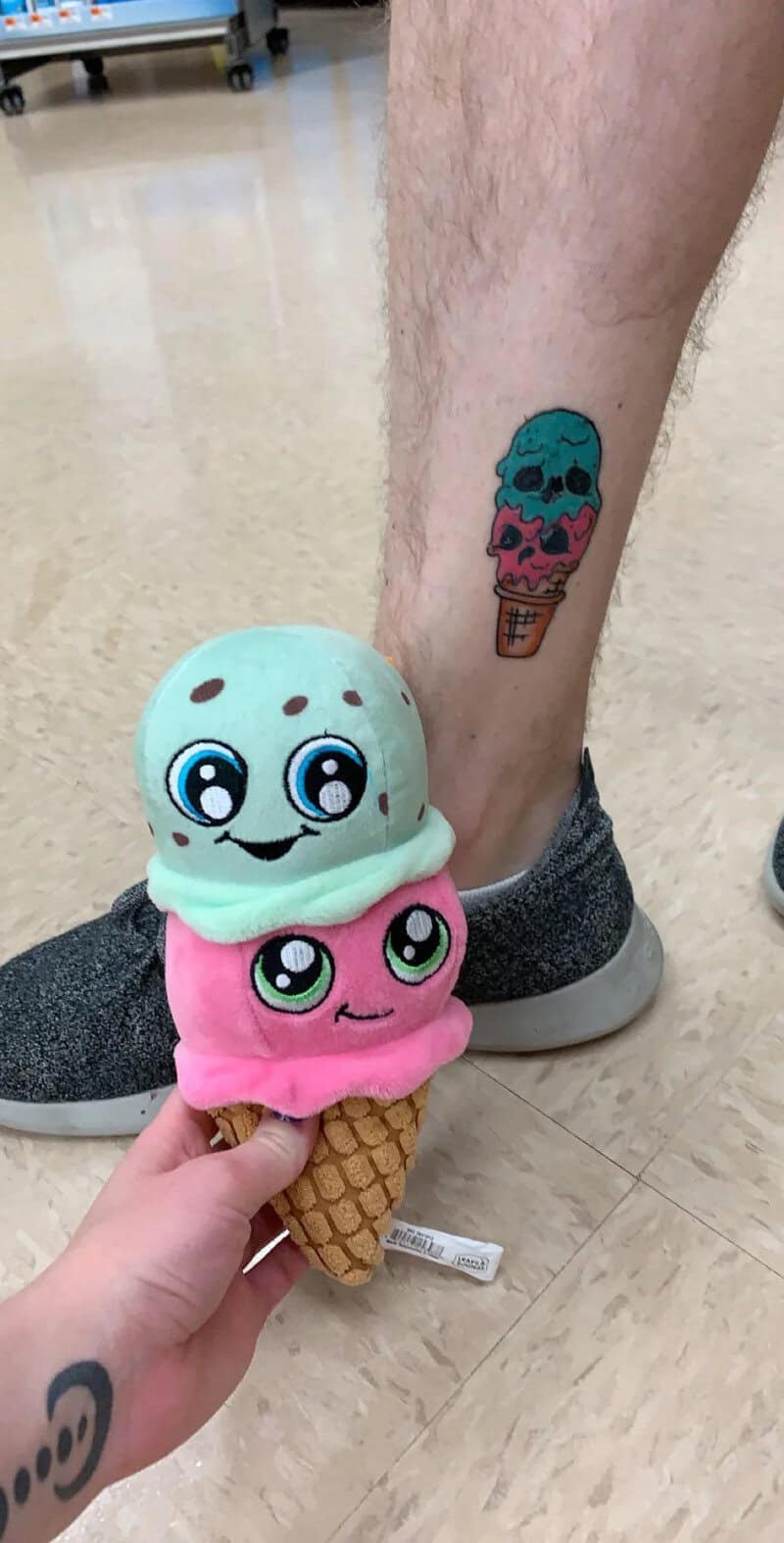 Tattoo of a colorful ice cream cone on a person's leg.
