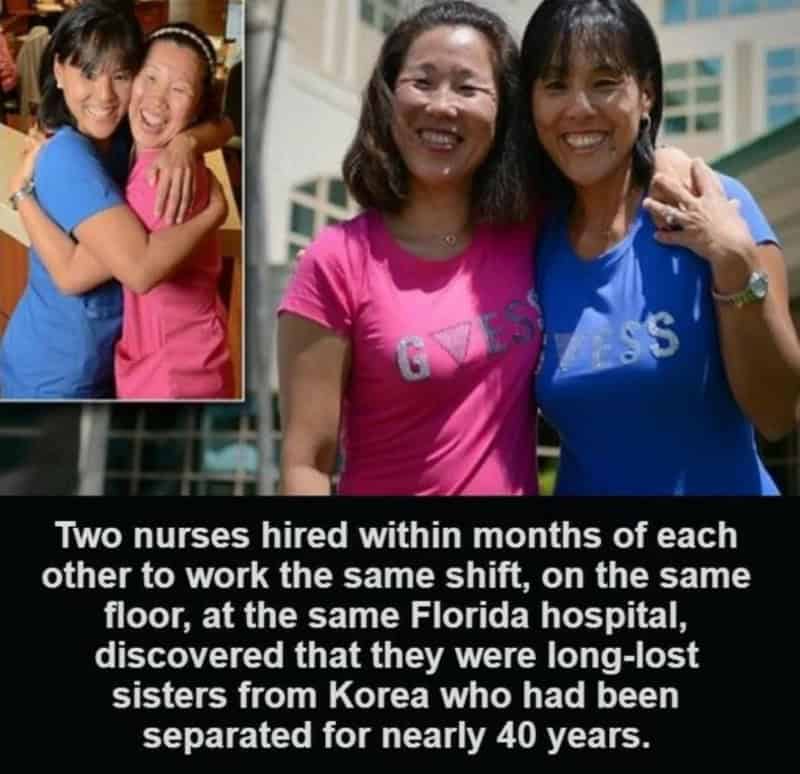 Two nurses in pink and blue shirts, smiling and embracing each other.