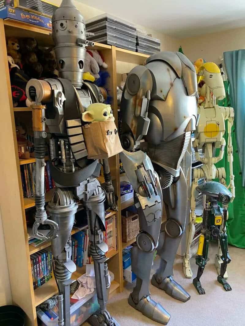 Collection of life-sized robot and character models in a room.