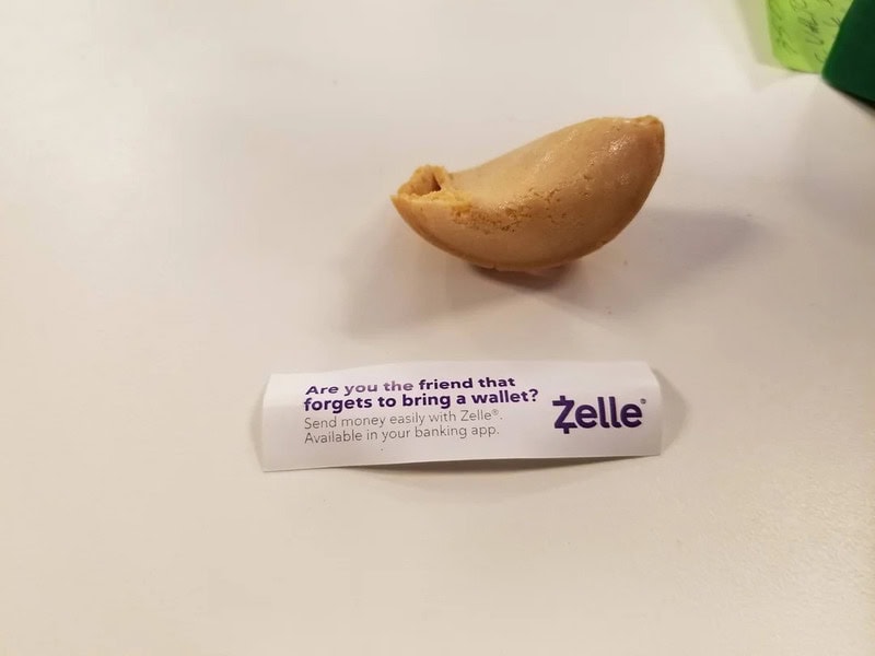 A fortune cookie with a Zelle advertisement underneath it.