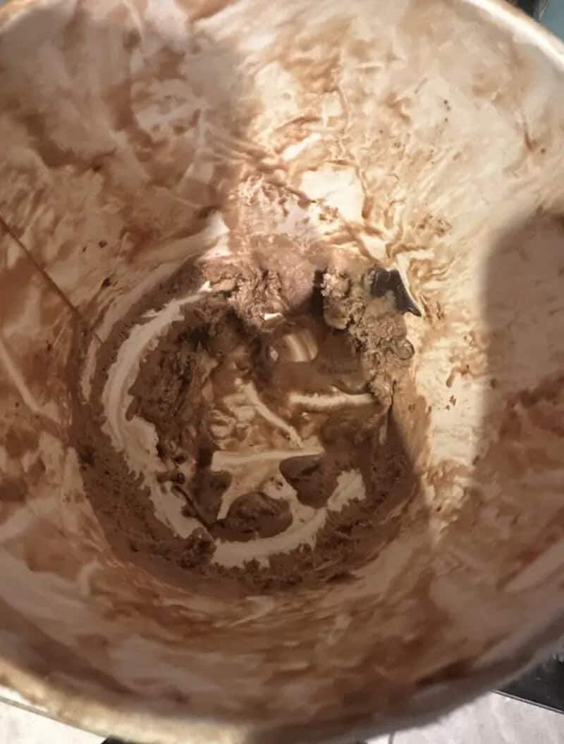 Dirty coffee mug with leftover coffee and stains inside.