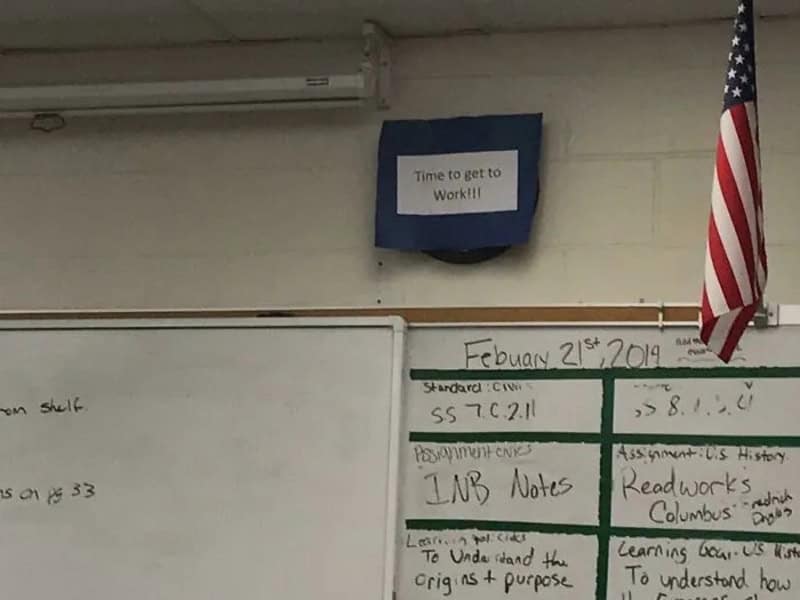 Classroom whiteboard with a sign saying 'Time to get to Work!!!' and a note about February 21, 2019.