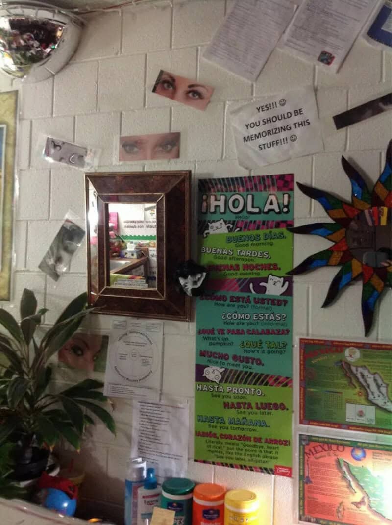 Wall with eyes, signs, and colorful decorations in a classroom or office.