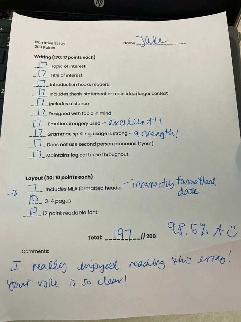 Handwritten notes on a grading sheet for a narrative essay, praising the essay's strengths.