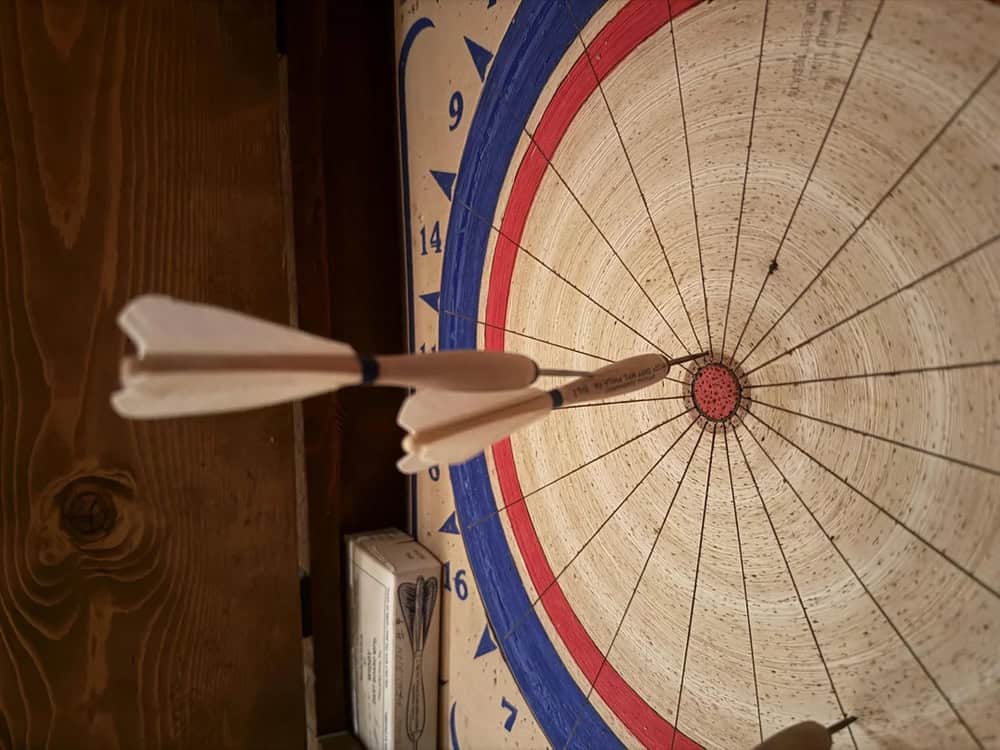 A dart hitting the bullseye on a dartboard.