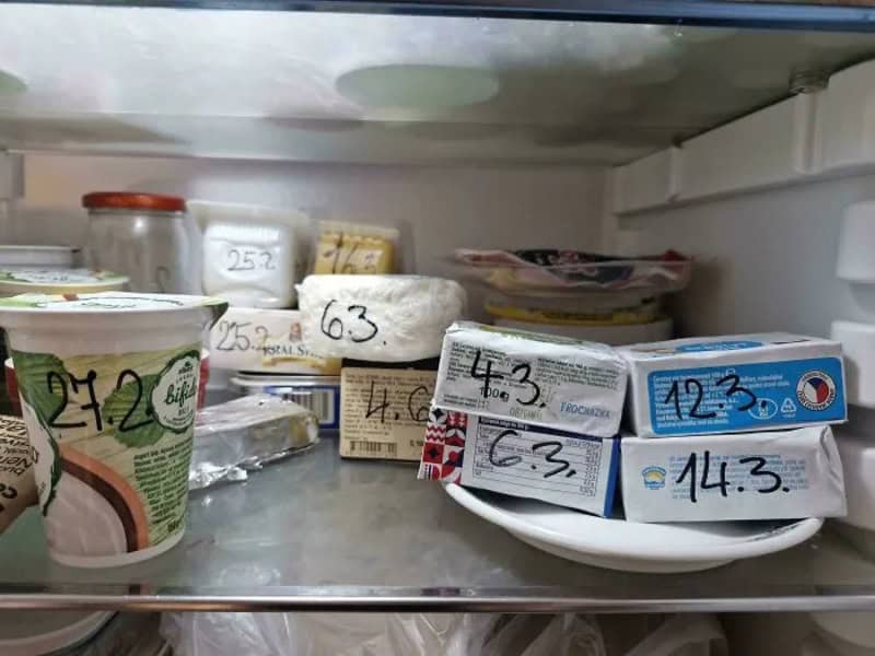 Inside of a refrigerator with various dairy products and labels.