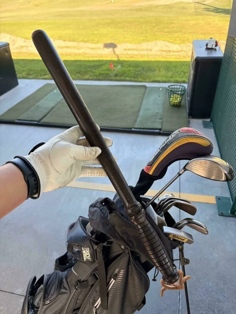 Golf club and bag with a golf course in the background.