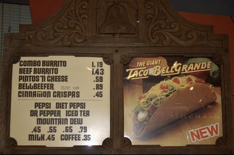 Menu board with taco and drink options at Taco Bell Grande from the 80s or 90s.