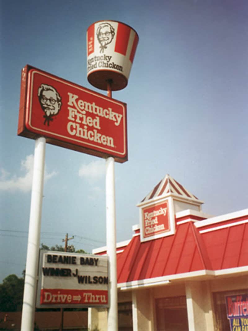Kentucky Fried Chicken sign with a bucket logo and drive-thru menu.