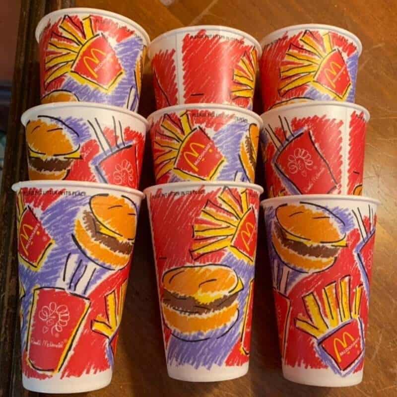 Colorful McDonald's cups with fries and burger illustrations from the 80s or 90s.
