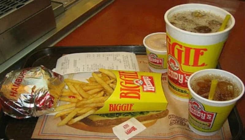 Fast food meal with burger, fries, and drinks from Wendy's, 80s or 90s style.