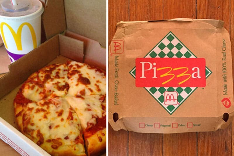 Pizza in a box with a McDonald's drink in the background.