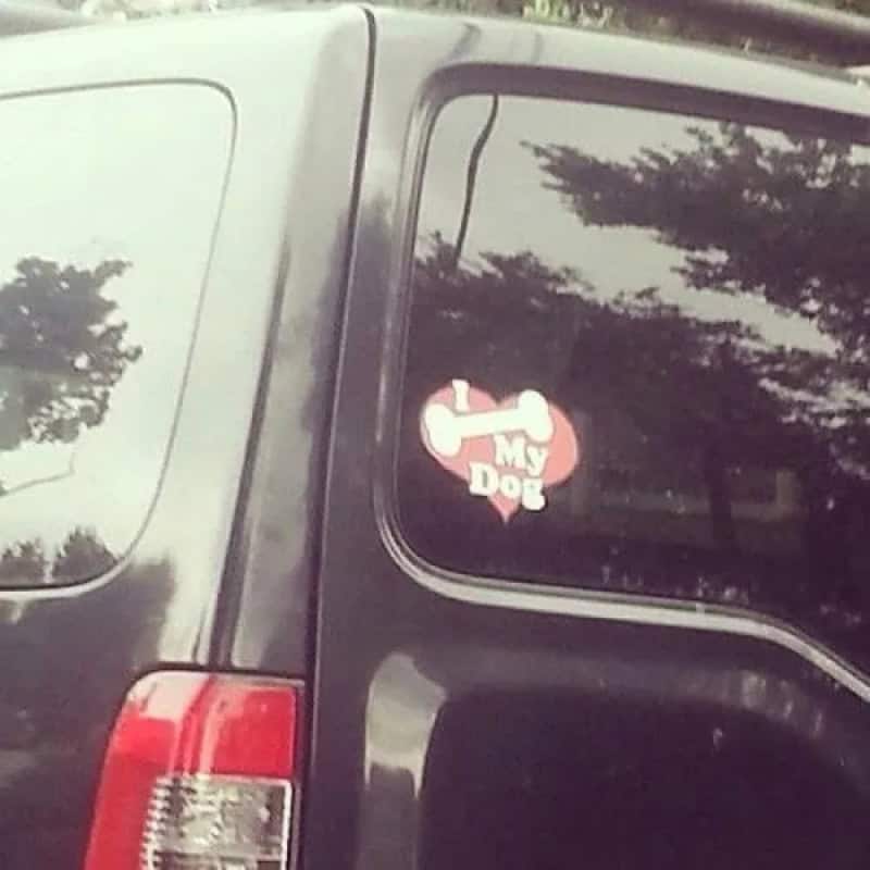 Car window sticker with a bone and heart, says "I love my dog".