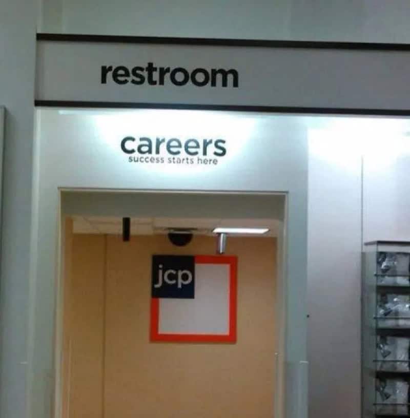 Restroom sign above a careers success starts here sign at an airport or mall.