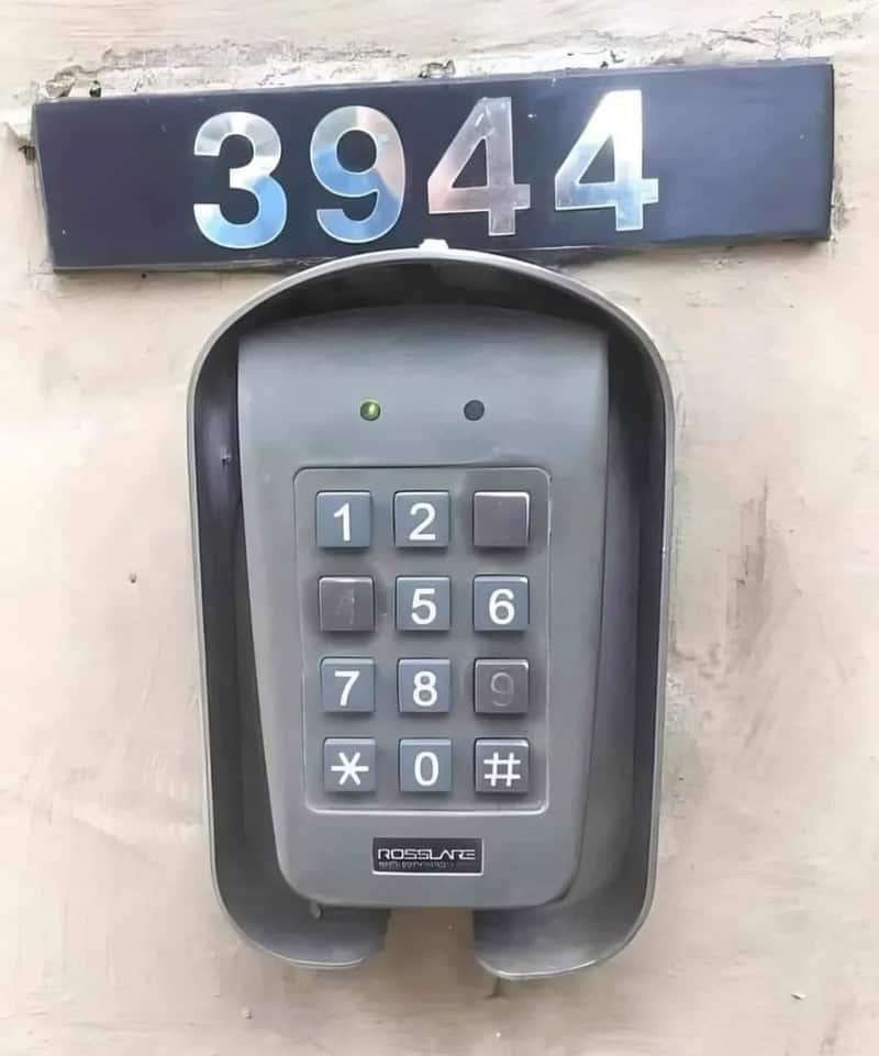 Keypad with the number 3944 above it on a wall.