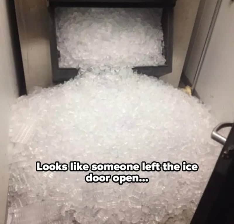 Ice spilled out of the open ice door onto the floor.