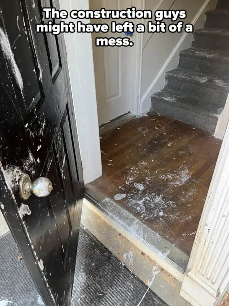 Messy entryway with construction dust and debris on the floor.