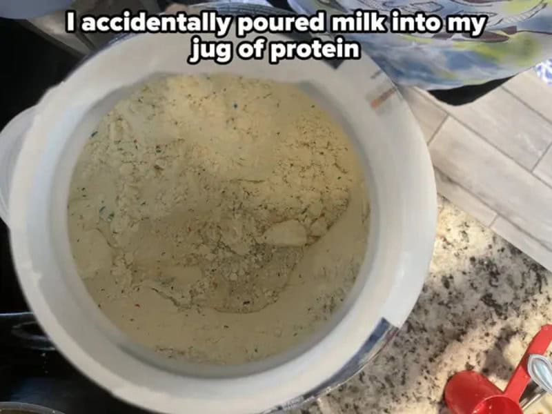 Powdered protein in a container with a caption about accidentally pouring milk into it.
