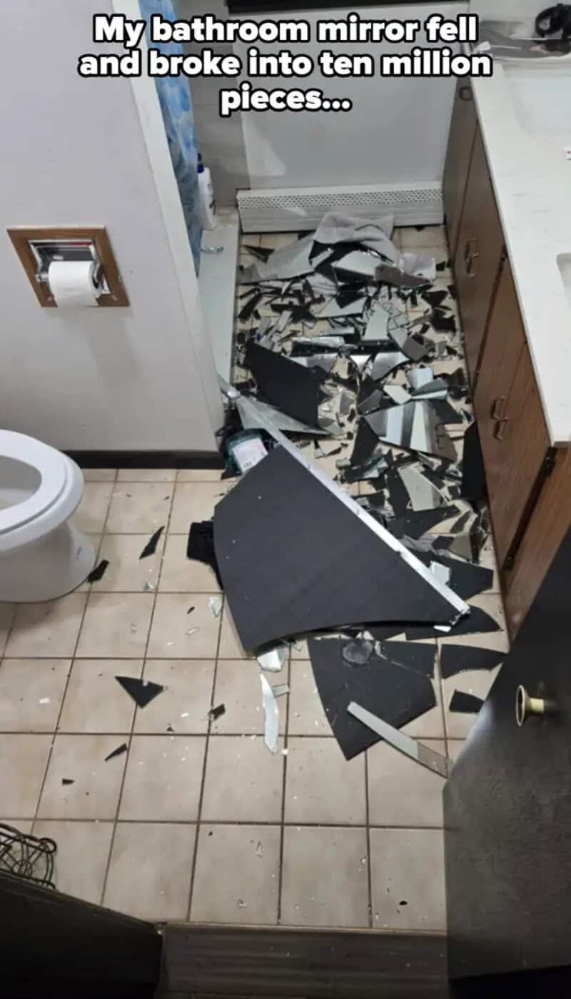 Bathroom mirror shattered into many pieces after falling.