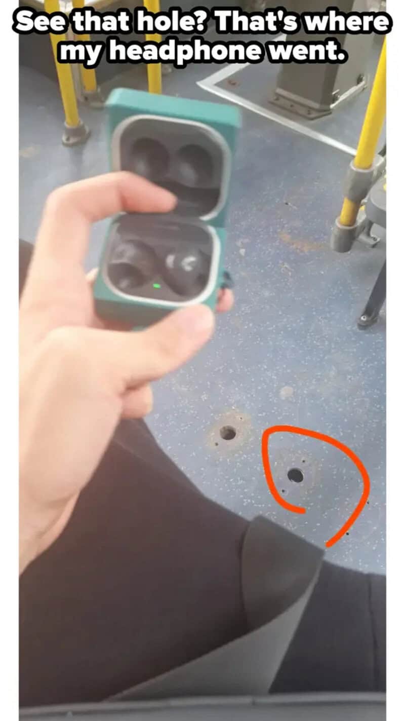 Person holding open AirPods case with hole on the floor nearby.