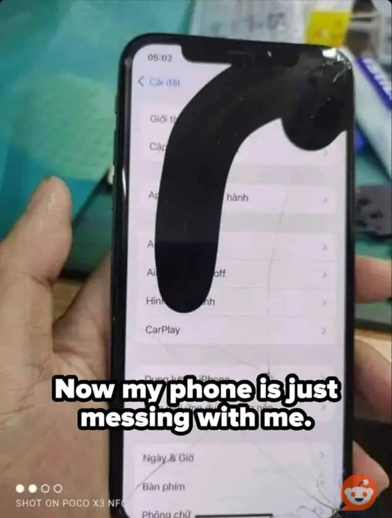 A phone with a large black object on the screen, with text saying 'Now my phone is just messing with.