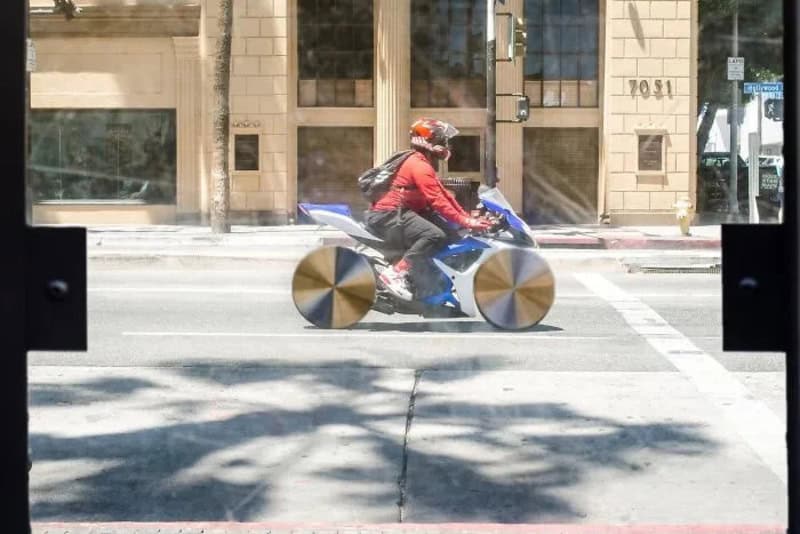 Person riding a bike with large wheels on a city street.