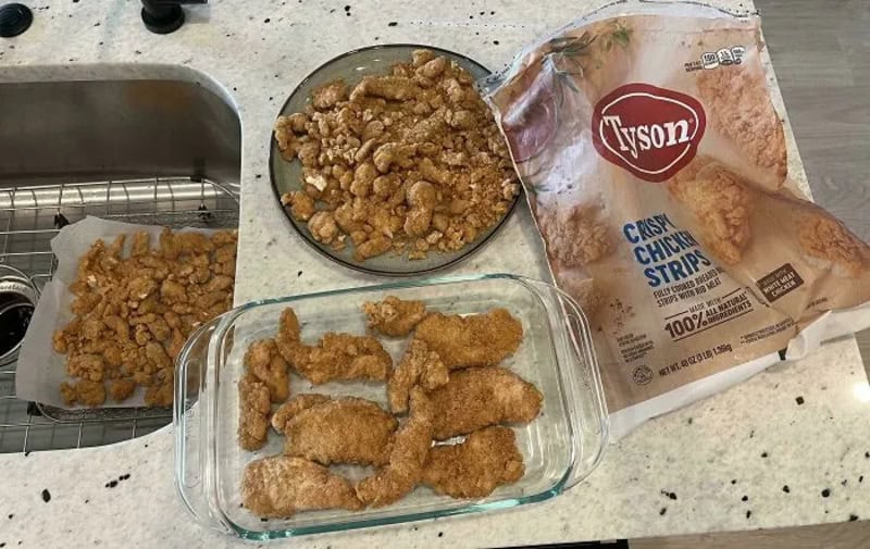 Fried chicken pieces, a bag of Tyson crispy chicken strips, and cooked chicken in a glass dish.