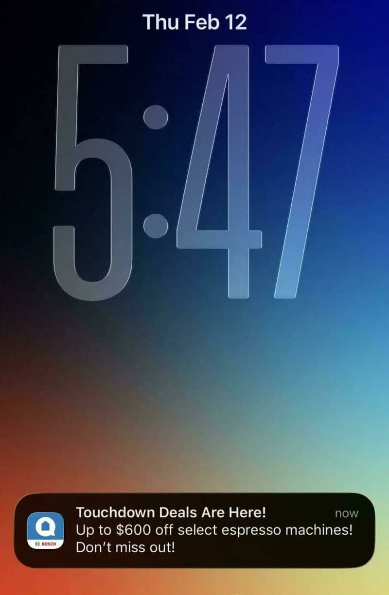 Smartphone lock screen showing date, time, and a notification about espresso machine deals.