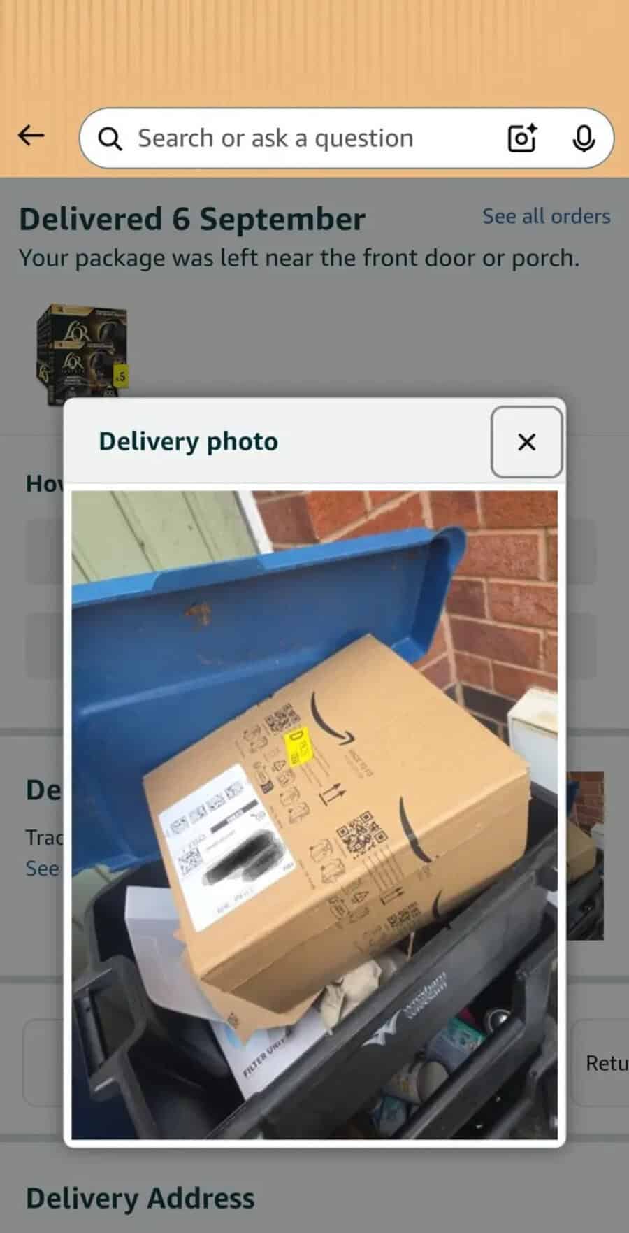 Package delivered on 6 September in a blue bin, with a cardboard box on top.